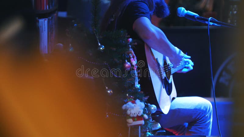 Bearded guitarist at concert - acoustic guitar, microphone, club