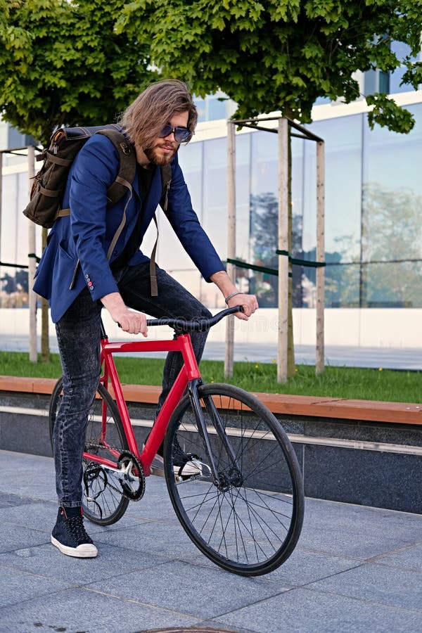 A Man with Backpack Sits on the Red Fixed Bicycle. Stock Image Image