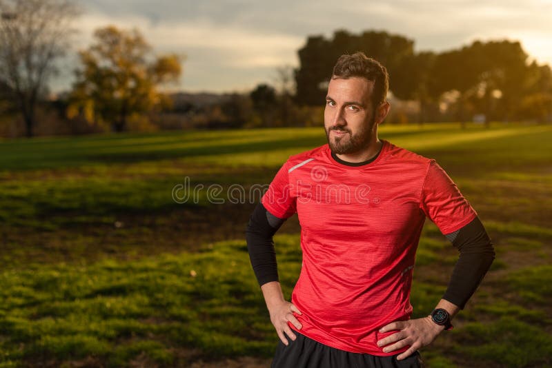 Confident Sportsman Standing with Hands on Waist in Park Stock Photo ...