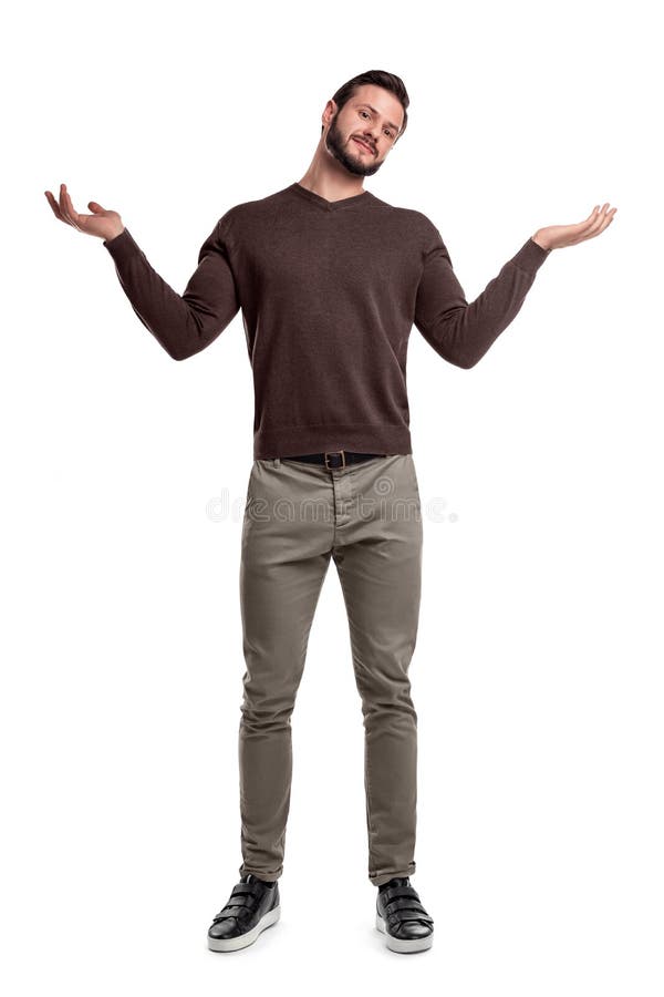 A bearded man in casual clothes stands with both arms up and a questioning face expression. stock images