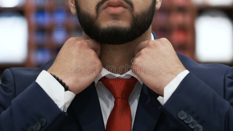 Bearded Man Hands Corrected Red Tie On A White Shirt