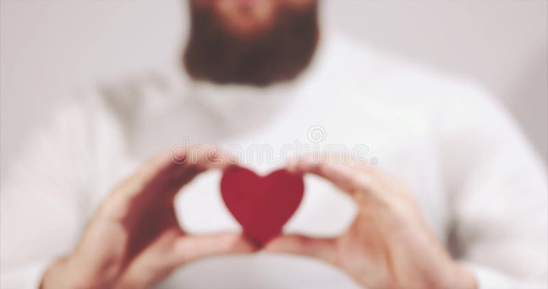Bearded man hands holding Heart shape Love and Health symbol stock video