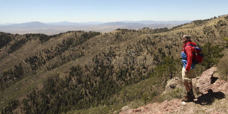 A Bearded Man Hiking in the Mountains