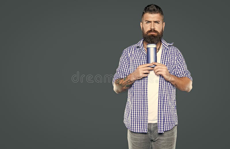 Bearded man holding male product of beard care cosmetics stock images