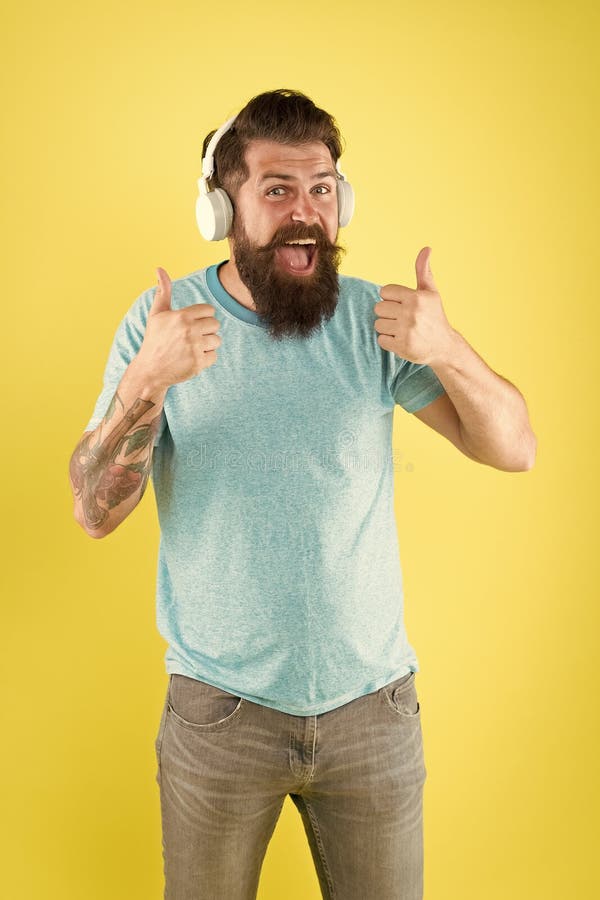 Bearded man listening music wireless gadget. Freedom going wireless offers you is unparalleled. Hipster happy using