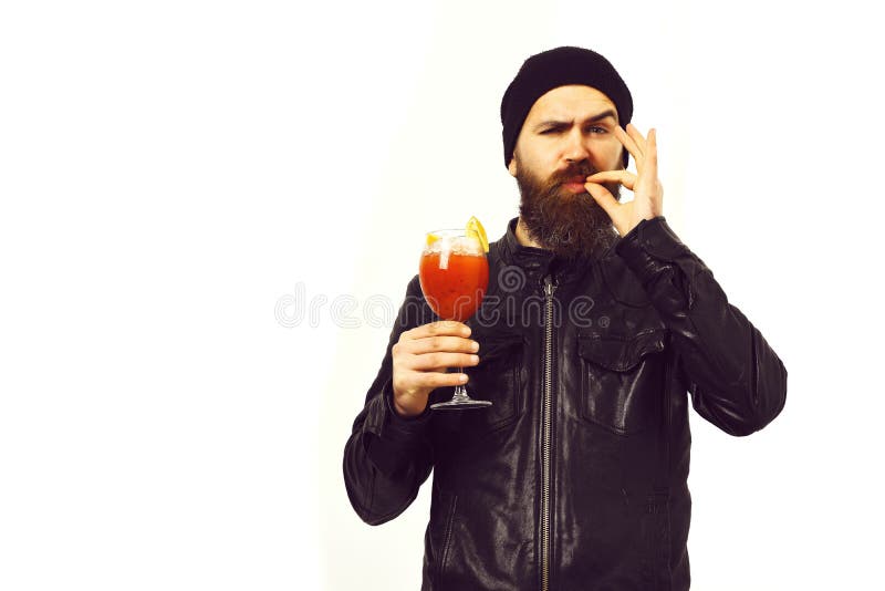 Brutal caucasian hipster holding alcoholic beverage or fresh cocktail. Bearded man, long beard. Brutal caucasian satisfied hipster with moustache holding glass stock image Brutal caucasian hipster holding alcoholic beverage or fresh cocktail. Bearded man, long beard. Brutal caucasian satisfied hipster with moustache holding glass stock image
