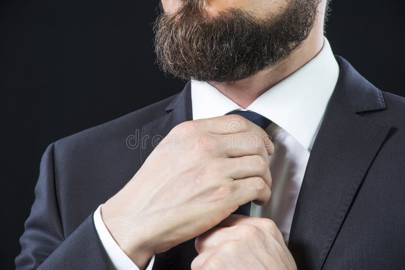 Bearded man tying up his necktie stock images Bearded man tying up his necktie stock images
