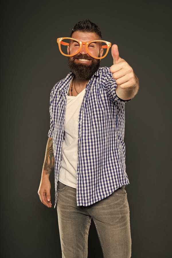 Bearded man wearing party glasses. Funny hipster in extravagant glasses. Fashion man with beard. Playful guy enjoying stock images Bearded man wearing party glasses. Funny hipster in extravagant glasses. Fashion man with beard. Playful guy enjoying stock images