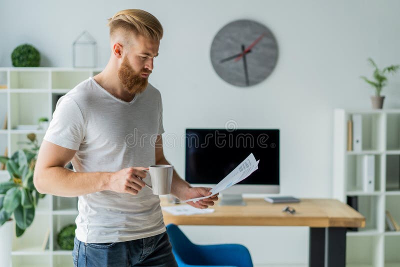 Bearded young businessman working at modern office. Man making notes on the documents. Notes office stock images, royalty-free photos and pictures