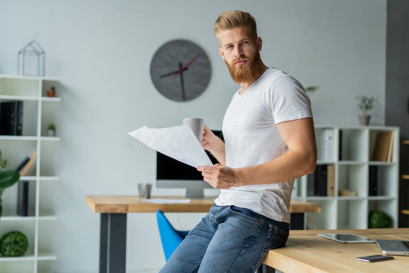 Bearded young businessman working at modern office. Man making notes on the documents. Notes office stock images, royalty-free photos and pictures