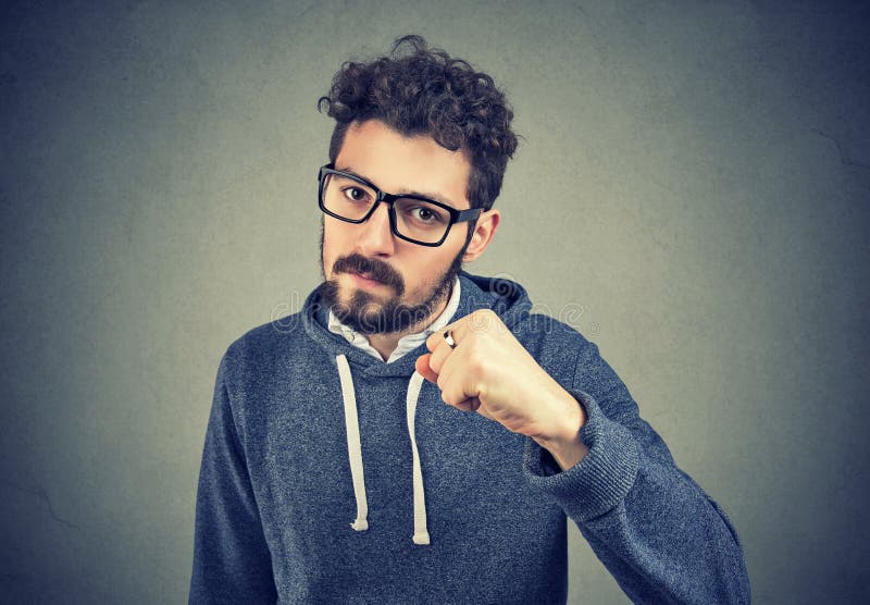 Aggressive man threatening with fist stock photo Aggressive man threatening with fist stock photo