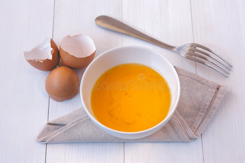 Beaten Egg Yolks In A Bowl With Fork Stock Image Image of napkin