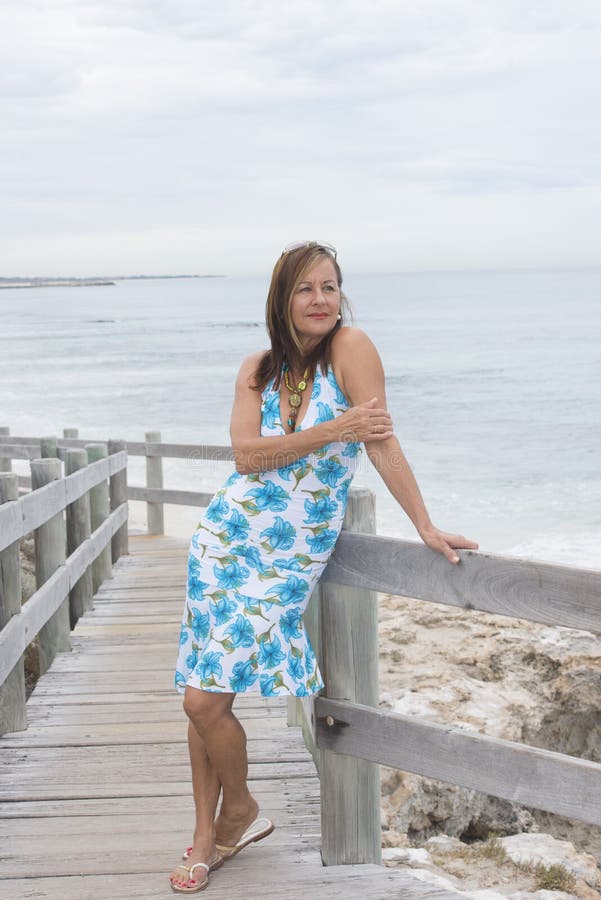 beatiful-senior-woman-beach-portrait-confident-attractive-mature-posing-happy-smiling-relaxed-standing-boardwalk-outdoor-39418493.jpg