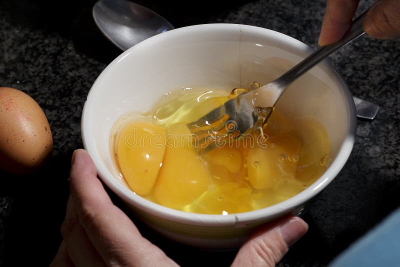 Beating eggs with fork stock photo. Image of cooking 38859596