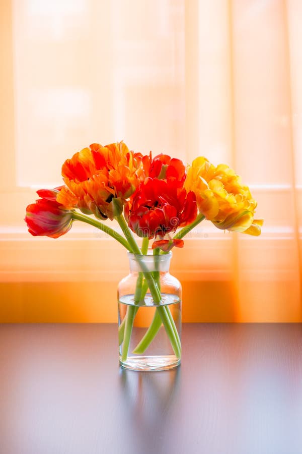 Beau bouquet de tulipes dans le vase sur la table près de la fenêtre photos stock Beau bouquet de tulipes dans le vase sur la table près de la fenêtre photos stock
