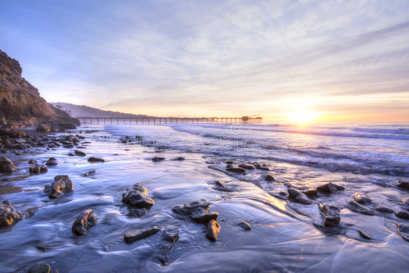 Colorfully vivid scenic southern California beach featuring Scripps pier in La Jolla at sunset with beautiful relfections. Colorfully vivid scenic southern California beach featuring Scripps pier in La Jolla at sunset with beautiful relfections