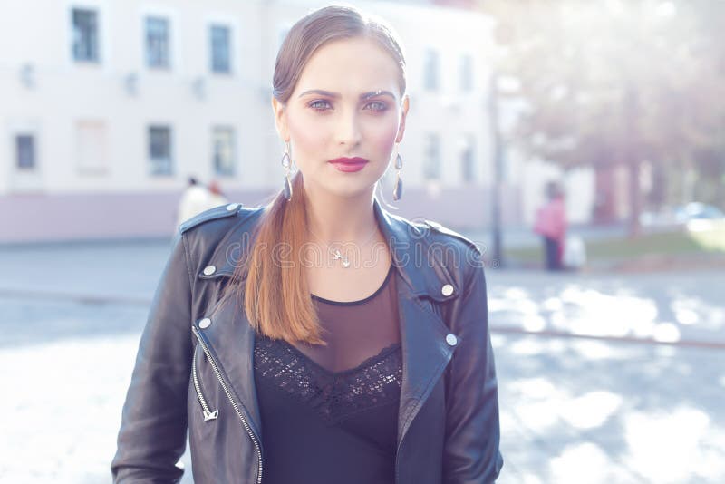 Beau tir d'une fille avec le maquillage à la mode lumineux dans la jupe en cuir noire à la lumière du soleil de luchas de style d photo libre de droits