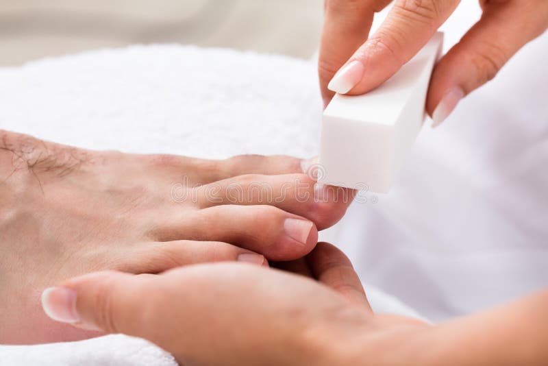 Beautician Hand Filing The Nails stock photo Beautician Hand Filing The Nails stock photo