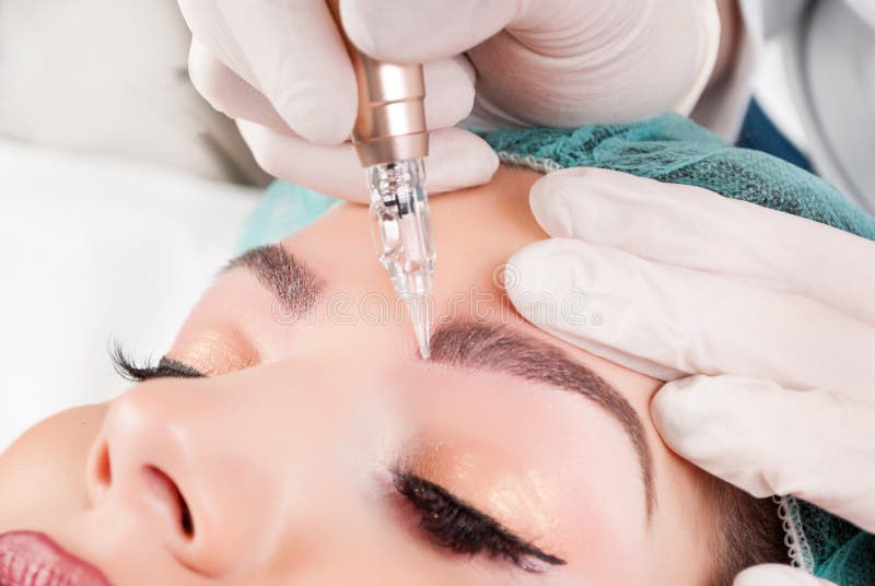 Beautician Hands Doing Eyebrow Tattoo On Woman Face stock photos Beautician Hands Doing Eyebrow Tattoo On Woman Face stock photos