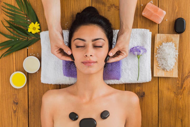 Beautician Make Stone Massage Spa For Woman At Wellness Center Stock