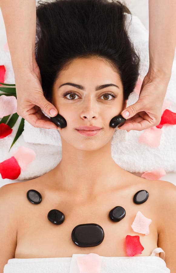 Beautician Make Stone Massage Spa For Woman At Wellness Center Stock