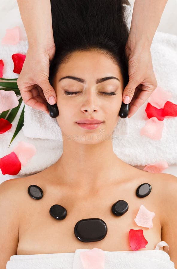 Beautician Make Stone Massage Spa For Woman At Wellness Center Stock