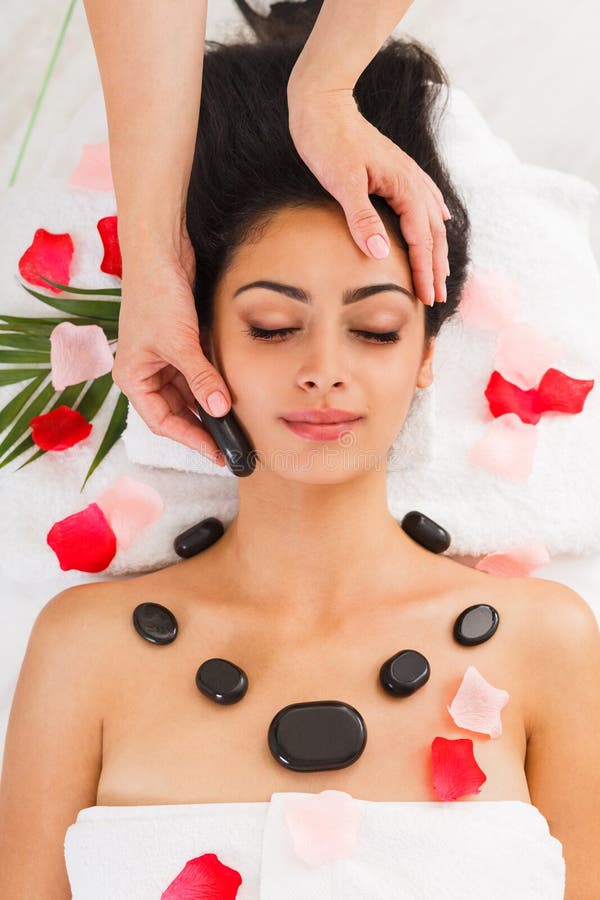 Beautician Make Stone Massage Spa For Woman At Wellness Center Stock