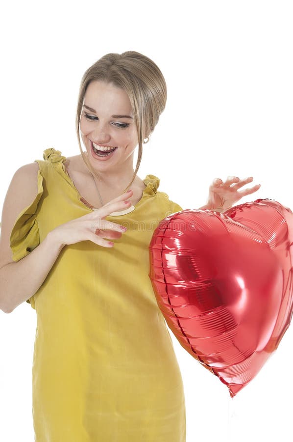 Beautifu funnyl woman holding red heart balloon
