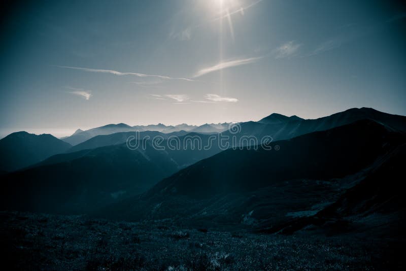 A beautiful, abstract monochrome mountain landscape in blue tonality.