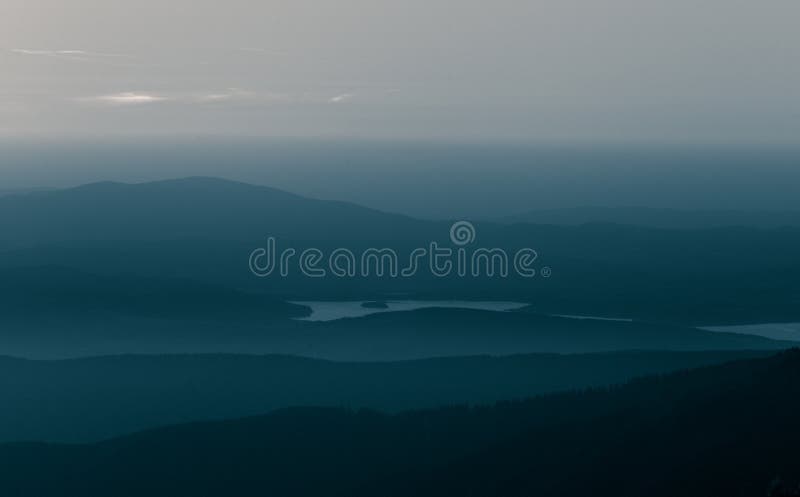 A beautiful, abstract monochrome mountain landscape in blue tonality.