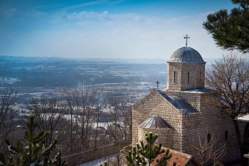 Beautiful view of the Beska Monastery in Zdrelo, Serbia overlooking vast fields under a blue sky