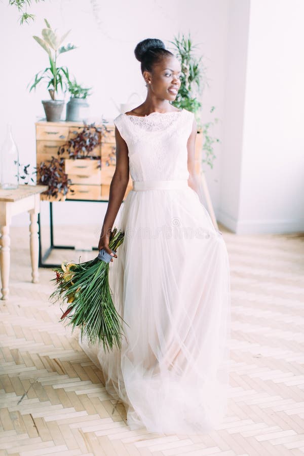 Beautiful african american bride with tropical bouquet in studio royalty free stock images