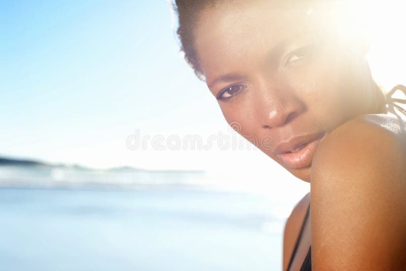 Close up portrait of a beautiful african american female fashion model at the beach