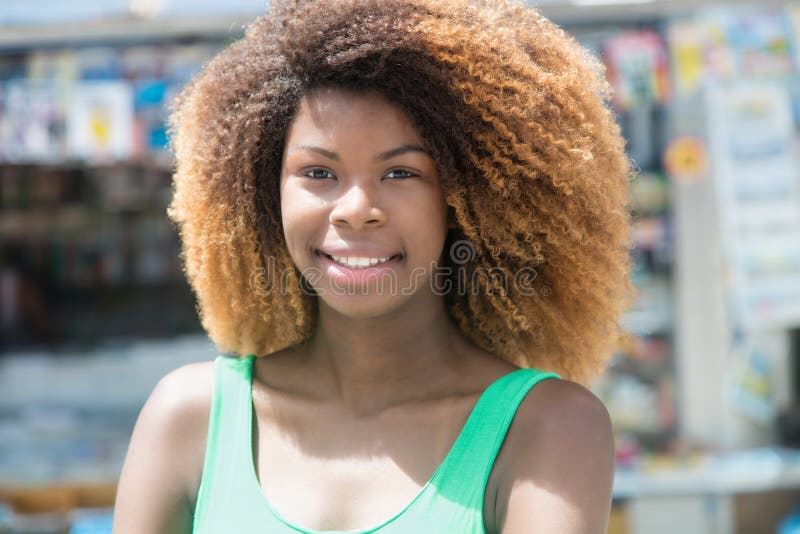 Beautiful african american girl with amazing hairstyle in the city