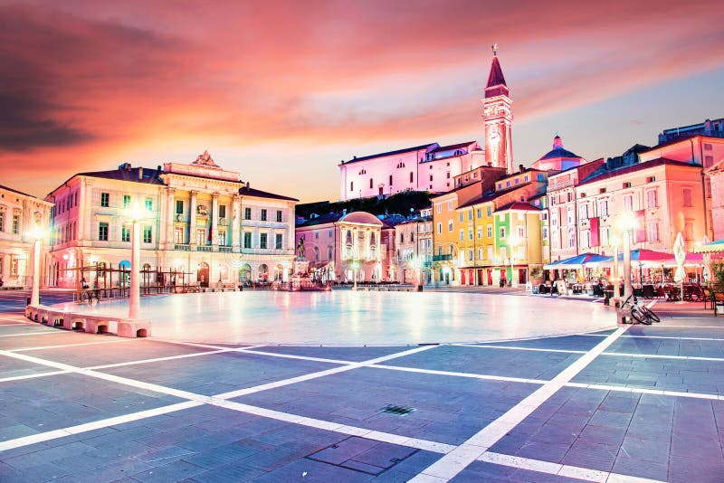 Beautiful amazing city scenery in the central square with the old clock tower in Piran, the tourist center of Slovenia in the stock photography Beautiful amazing city scenery in the central square with the old clock tower in Piran, the tourist center of Slovenia in the stock photography