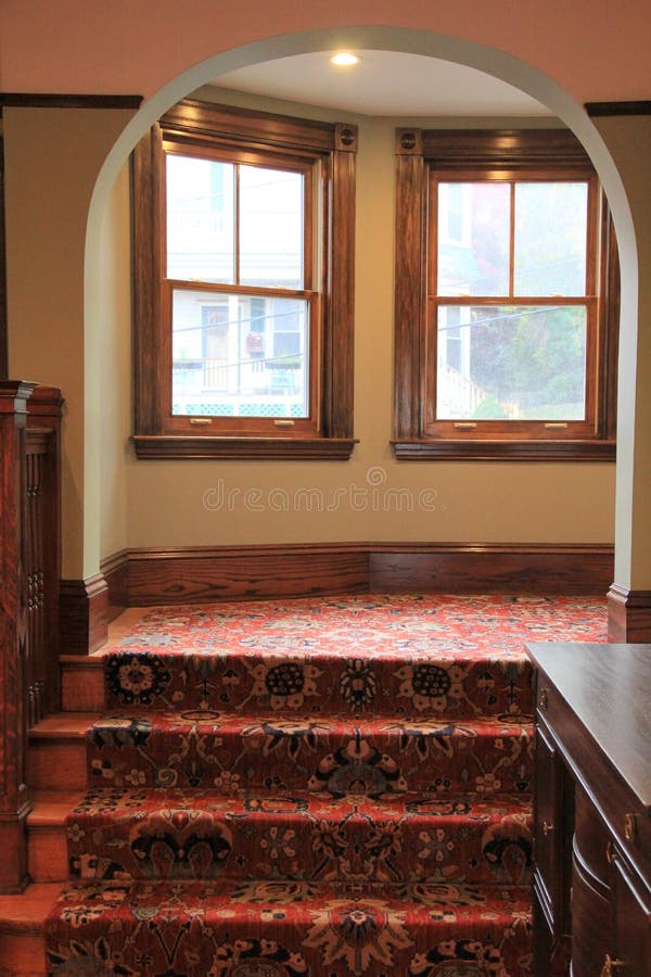 Beautiful archway, with warm wood and carpeting in home stock images Beautiful archway, with warm wood and carpeting in home stock images