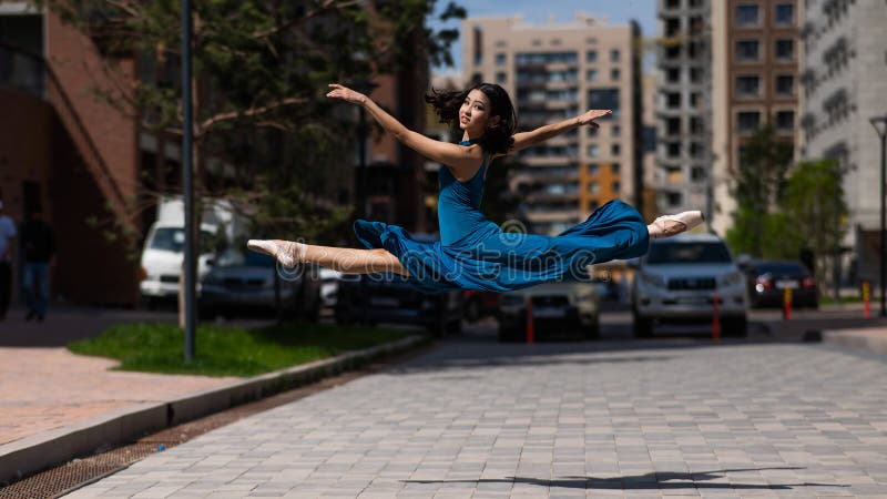 Beautiful Asian Ballerina Dancing Outdoors. Urban Landscape. Grand Jete ...