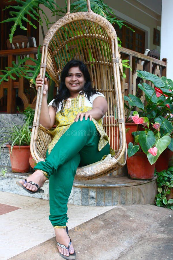 Beautiful Asian Girl in Bamboo Swing Chair