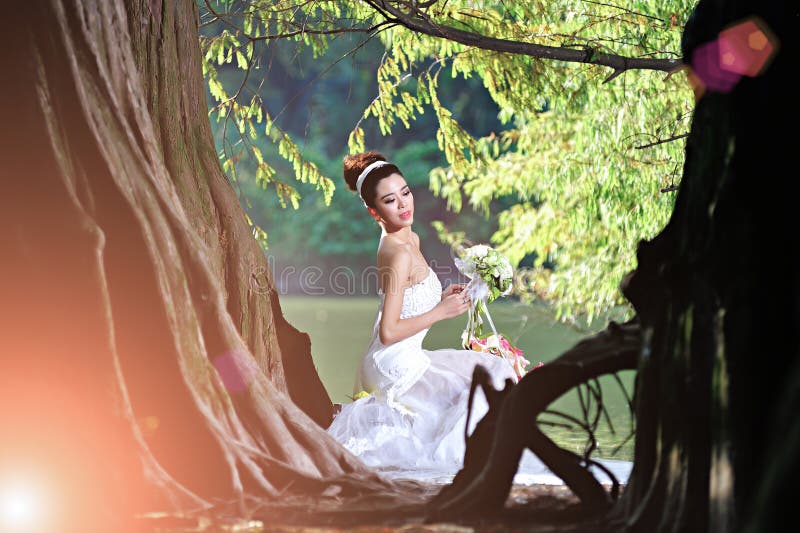 Beautiful Asian girl in a wedding dress showing happy moments royalty free stock photo Beautiful Asian girl in a wedding dress showing happy moments royalty free stock photo