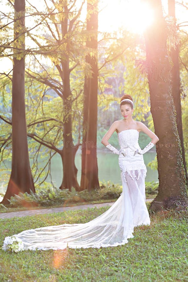 Beautiful Asian girl in a wedding dress showing happy moments royalty free stock photo Beautiful Asian girl in a wedding dress showing happy moments royalty free stock photo