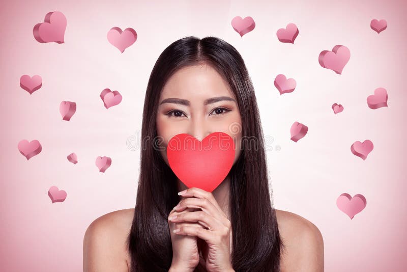 Beautiful asian girl holding red heart