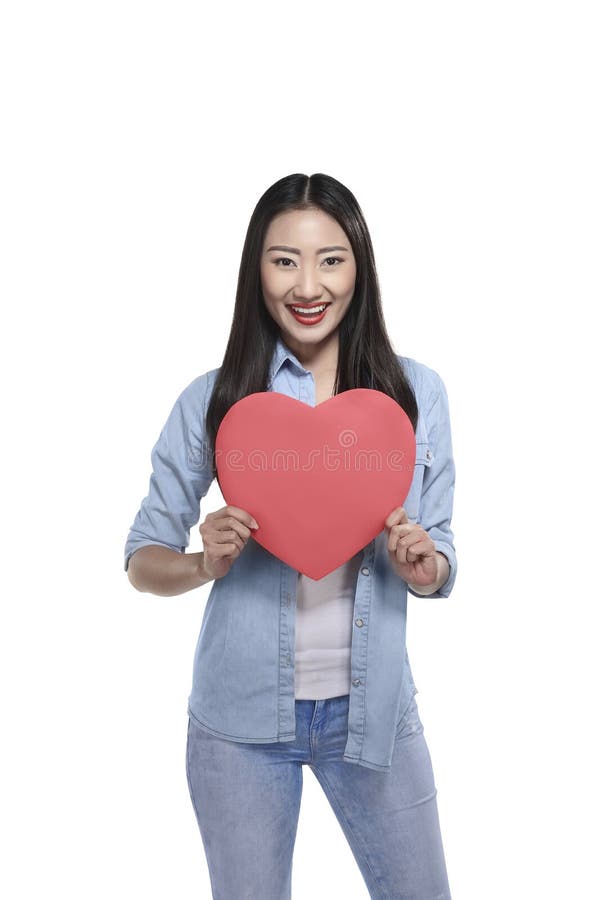 Beautiful asian girl holding red heart