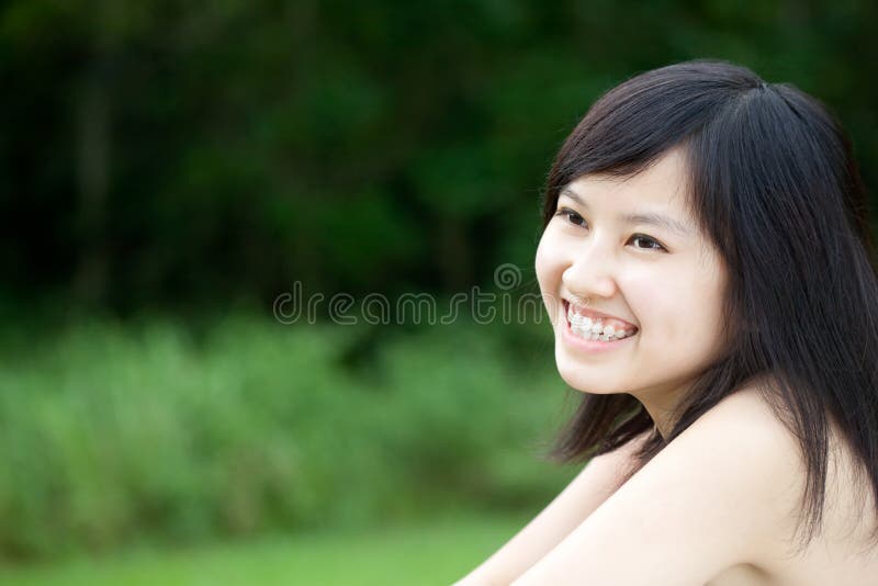 Beautiful Asian girl laughing outdoors