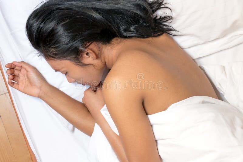 Naked woman sleep at bed.