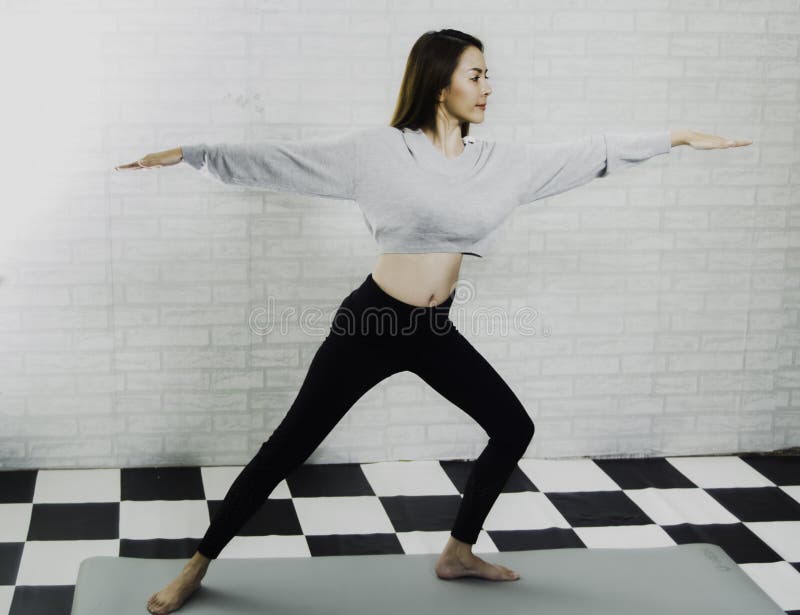 Beautiful Asian girl trainer, teaching yoga post on foam, with white brick wall as a background, exercise concept with yoga and stock photos Beautiful Asian girl trainer, teaching yoga post on foam, with white brick wall as a background, exercise concept with yoga and stock photos