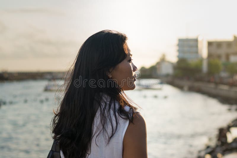 Beautiful asian lady near ocean during sunset royalty free stock photos Beautiful asian lady near ocean during sunset royalty free stock photos