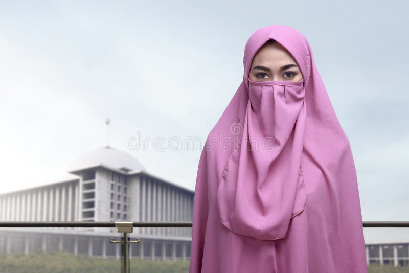 Beautiful asian muslim woman with niqab standing