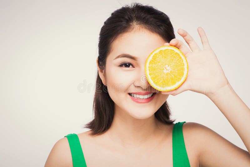 Beautiful asian portrait of young woman with oranges. Healthy food concept. Skin care and beauty. Vitamins and minerals royalty free stock photo Beautiful asian portrait of young woman with oranges. Healthy food concept. Skin care and beauty. Vitamins and minerals royalty free stock photo