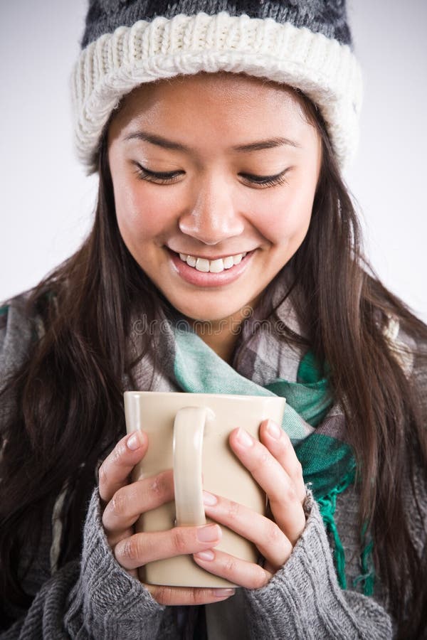 A shot of a happy beautiful asian woman drinking coffee