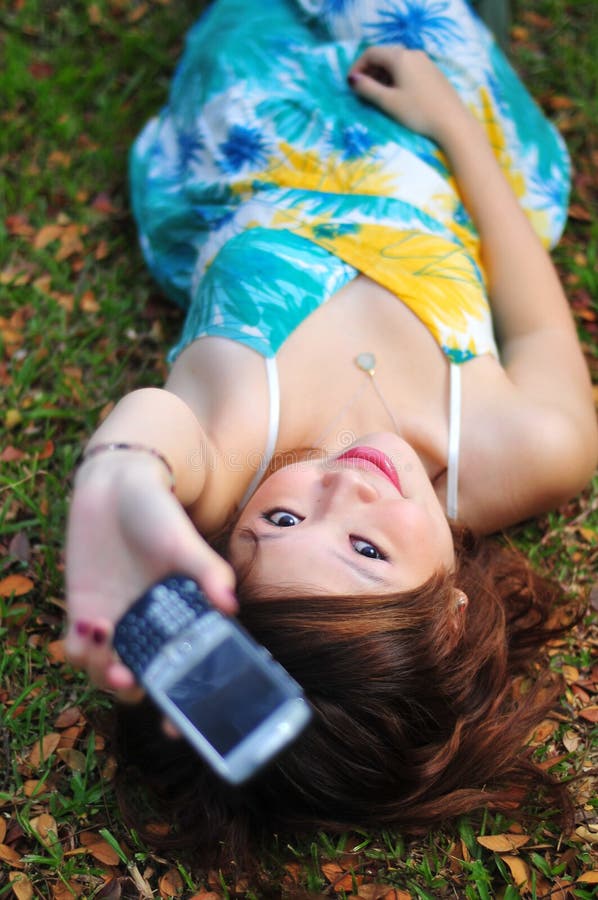 Beautiful Asian Woman Holding Mobile Phone.